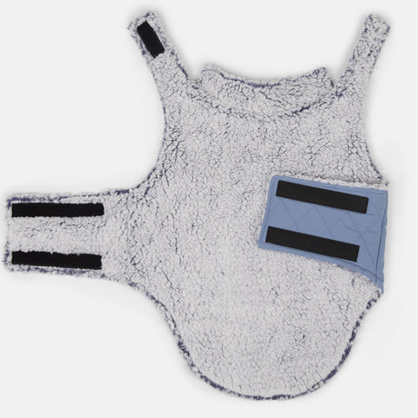 The Stratus Lite Reversible Dog Jacket by Clearance is a soft white fleece harness with two velcro straps and a light blue quilted patch, offering comfort, style, and easy fastening for your pet.