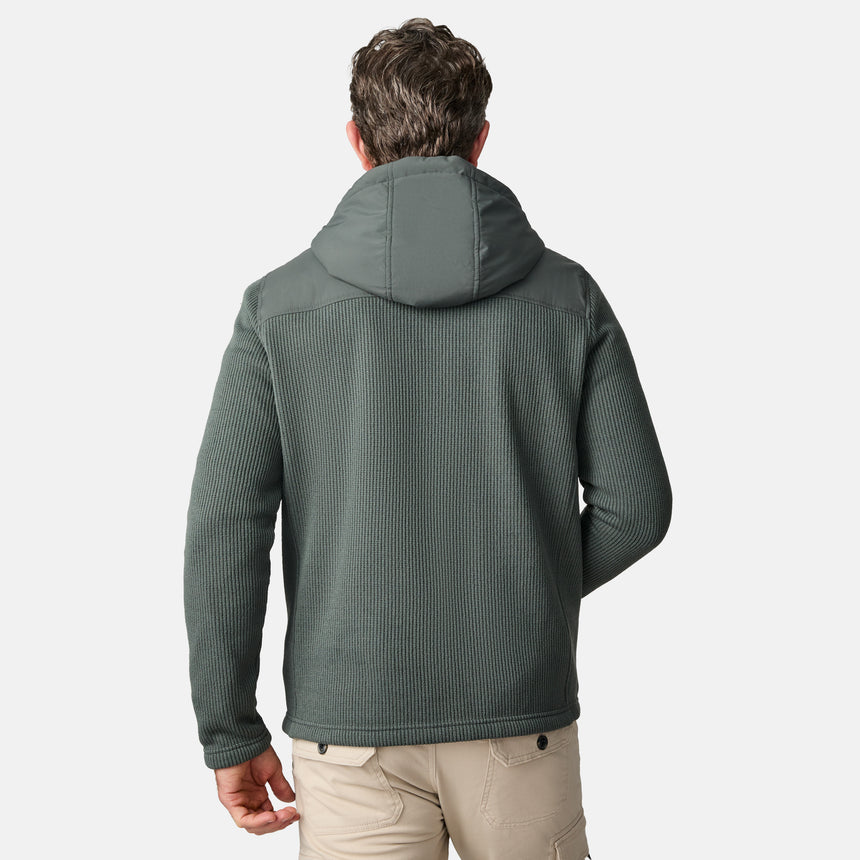 [Kolby is 6'2" wearing size M.] Men’s Free Country green hooded jacket with full-zip front, zippered chest pocket, and dual side hand pockets—featuring textured fabric and a clean outdoor silhouette. Paired with beige pants for a rugged, cool-weather look.
