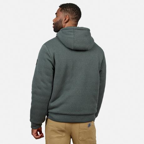 Back view of a man wearing a teal knit fleece jacket with a hood.
