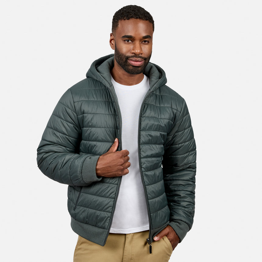 Mid-torso view of man in a dark green zip-front hooded fleece jacket with tan pants, one hand near the zipper.
