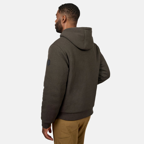 Side view of man in olive green Chayote fleece reversible jacket with hood and knit cuffs.