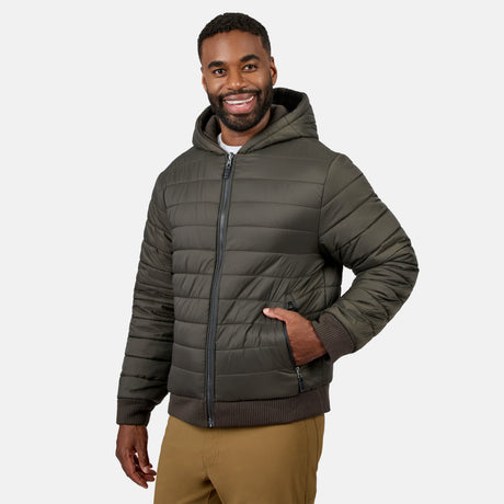 Man wearing olive green Chayote fleece reversible jacket with hood, zipped up and smiling.