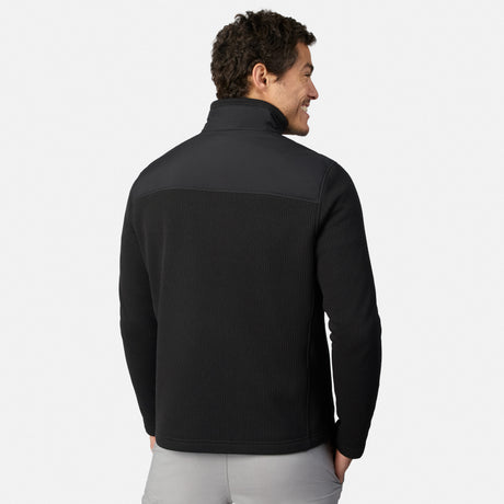 [Model is wearing size M.] A man wearing a black quarter-zip fleece pullover, shown from the back and side profile against a light gray studio background.