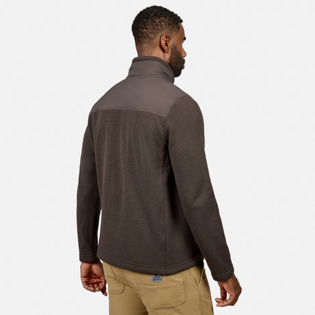 [Model is wearing size M.] A man wearing a dark brown ribbed quarter-zip fleece pullover with contrasting dark gray shoulder panels, shown from a rear three-quarter view against a light gray studio background.