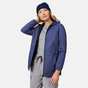 [Model is wearing size S.] Side profile of a woman wearing a navy X2O Thermo Rain Jacket and knit beanie 