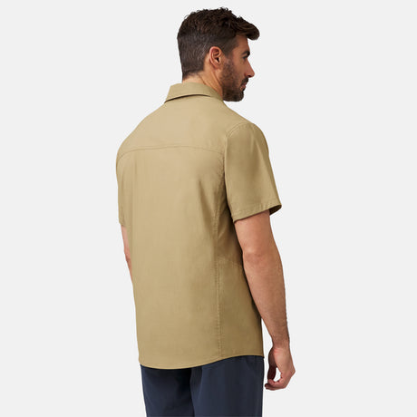 [Justin is 6'1" wearing a size Medium.] Man wearing the Free Country Men's Acadia Short Sleeve Shirt in Wheat, size M, featuring a short sleeves, mesh underarm panels for breathability, and a zipper chest pocket made from lightweight polyester fabric, styled with khaki shorts #color_ wheat