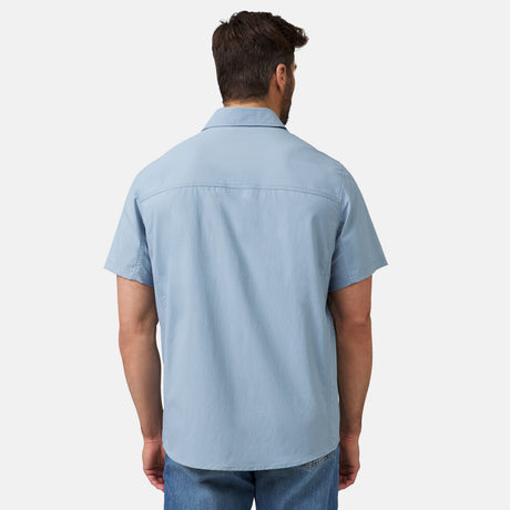 [Justin is 6'1" wearing a size Medium.] Man wearing the Free Country Men's Acadia Short Sleeve Shirt in cloud, size M, featuring a short sleeves, mesh underarm panels for breathability, and a zipper chest pocket made from lightweight polyester fabric, styled with khaki shorts #color_ cloud