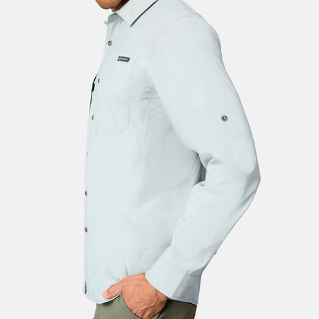 A man in a Free Country Men's Acadia Long Sleeve Shirt with a chest pocket and olive green pants, shown from the side against a plain white background.
