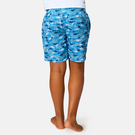 [Model is wearing a size Medium.] Boy wearing the Free Country Boys' Reel Catch Swim Short in Wave Reel Catch, size M, featuring recycled polyester fabric and elastic waistband and upf protection, paired with white sunshirt #color_ wave-reel-catch
