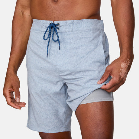 [Anderson is 6'2" wearing a size Medium.] Man wearing Free Country Men's Textured Surf Swim Short in Iron, size M, made from moisture wicking stretch performance fabric featuring a half back elastic waistband and fly front drawstring front closure #color_iron