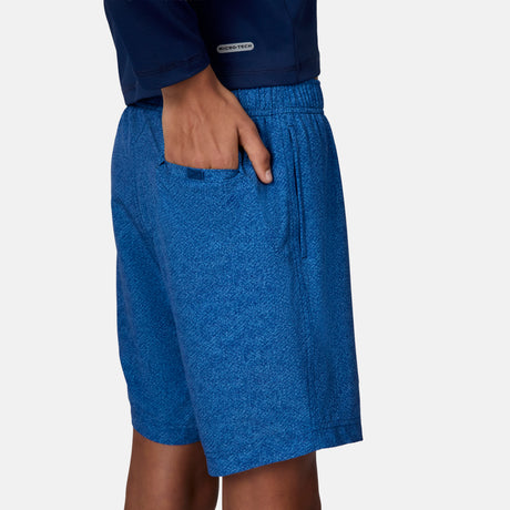 [Emporer is wearing size 10/12 Medium] child wearing blue textured swim shorts with a brand logo on a white background.