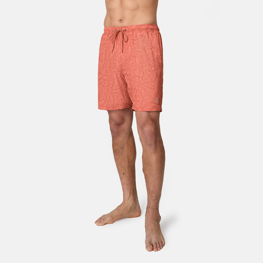 [Model is wearing size M] Person wearing coral patterned shorts on a white background