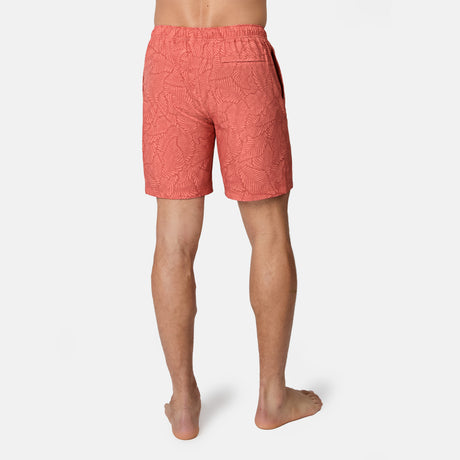 [Model is wearing size M] Back view of person wearing coral patterned shorts on a white background