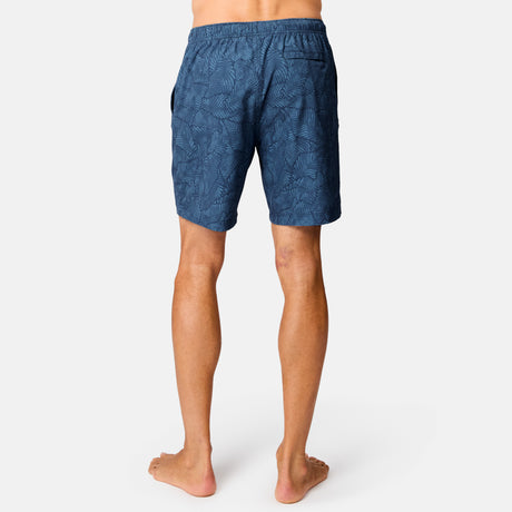 [Model is wearing size M] Person wearing blue patterned shorts on a white background