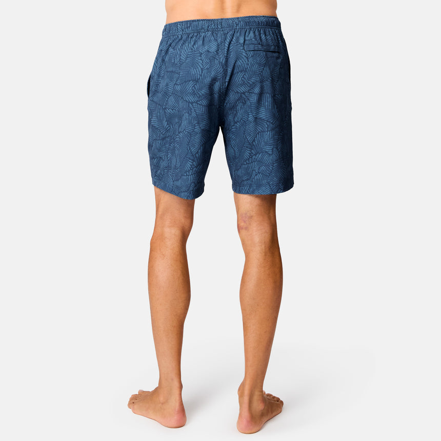 [Model is wearing size M] Person wearing blue patterned shorts on a white background