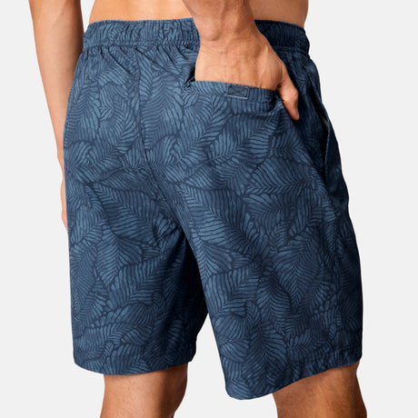 [Model is wearing size M] Blue patterned shorts worn by a person on a white background