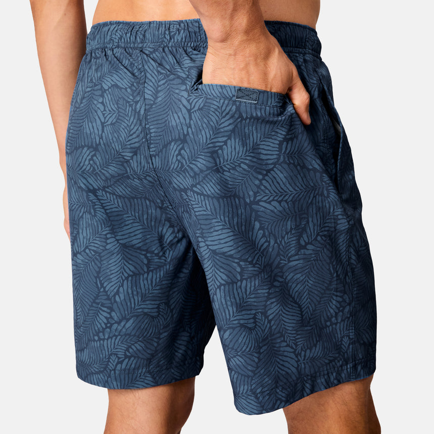 [Model is wearing size M] Blue patterned shorts worn by a person on a white background