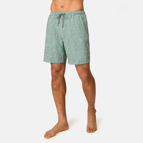 [Model is wearing size M] Green patterned shorts worn by a person on a white background