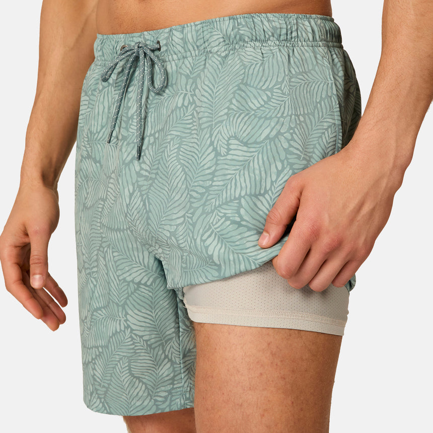 [Model is wearing size M] Green leaf-patterned shorts worn by a person on a neutral background