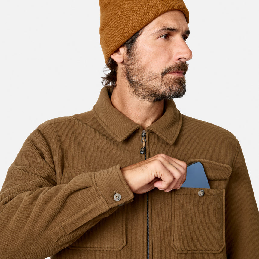 [Model is wearing size M.] A man wearing a brown corduroy jacket and a matching brown beanie, shown in a close-up profile view against a light gray background.