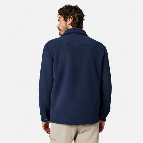 [Model is wearing size M.] A man viewed from the back wearing a navy blue fleece button-up shirt jacket and beige pants, set against a plain light gray studio background.