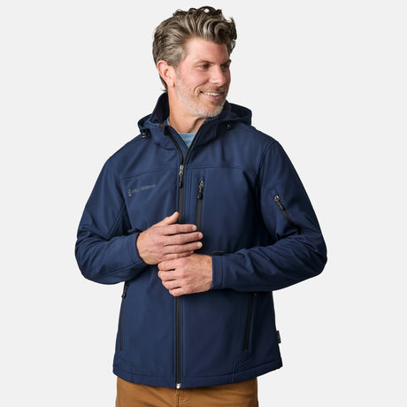 [Kolby is 6'2" wearing size M.] Man wearing Free Country Men's Odyssey II Flex Super Softshell® Jacket in navy with a full front zipper opening, adjustable cuff openings, and wind and water resistant stretch performance fabric, light grey background. Perfect men’s jacket for fall weather.