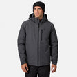 [Model is wearing size M.] A man wearing a dark gray hooded technical jacket with a black beanie, standing against a light gray studio background.