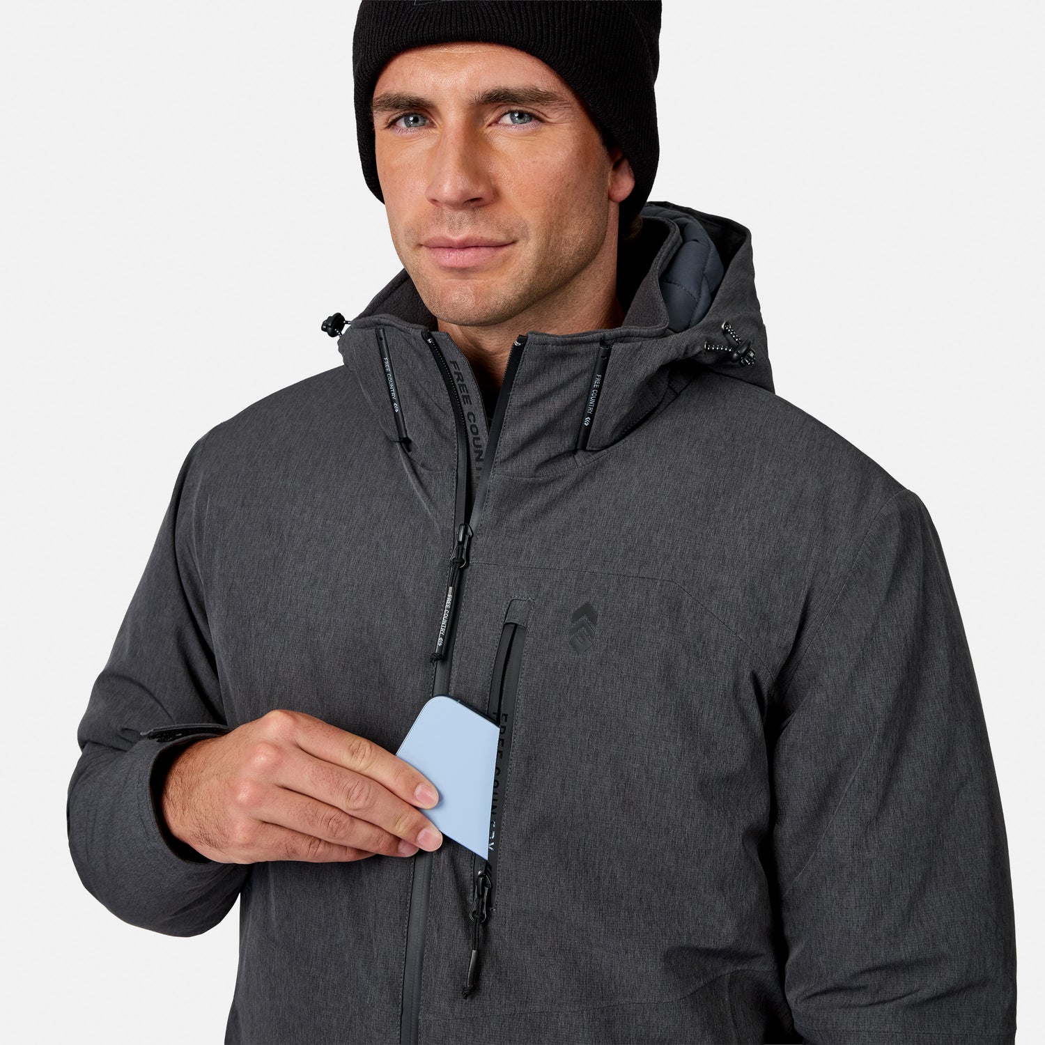[Model is wearing size M.] A man wearing a dark gray hooded jacket and black beanie, holding a light blue card in the front pocket of the jacket, against a light gray background.