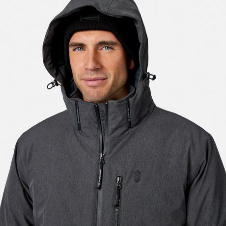 [Model is wearing size M.] A man wearing a dark gray hooded technical jacket and a black knit beanie, shown from the chest up against a light gray studio background.