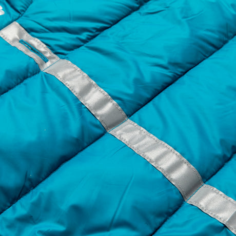 Close-up of the Clearance Dog Down Reversible Mock Jacket's blue quilted, water-resistant fabric featuring silver reflective strips sewn across the seams.