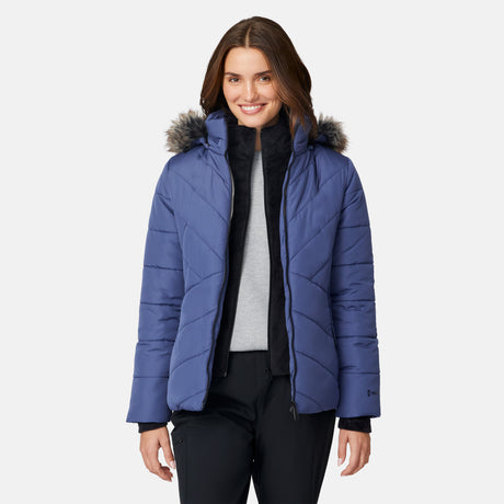 [Jessica is 5'9.5" wearing size S.] Woman wearing a blue puffer jacket with a fur-lined hood on a white background