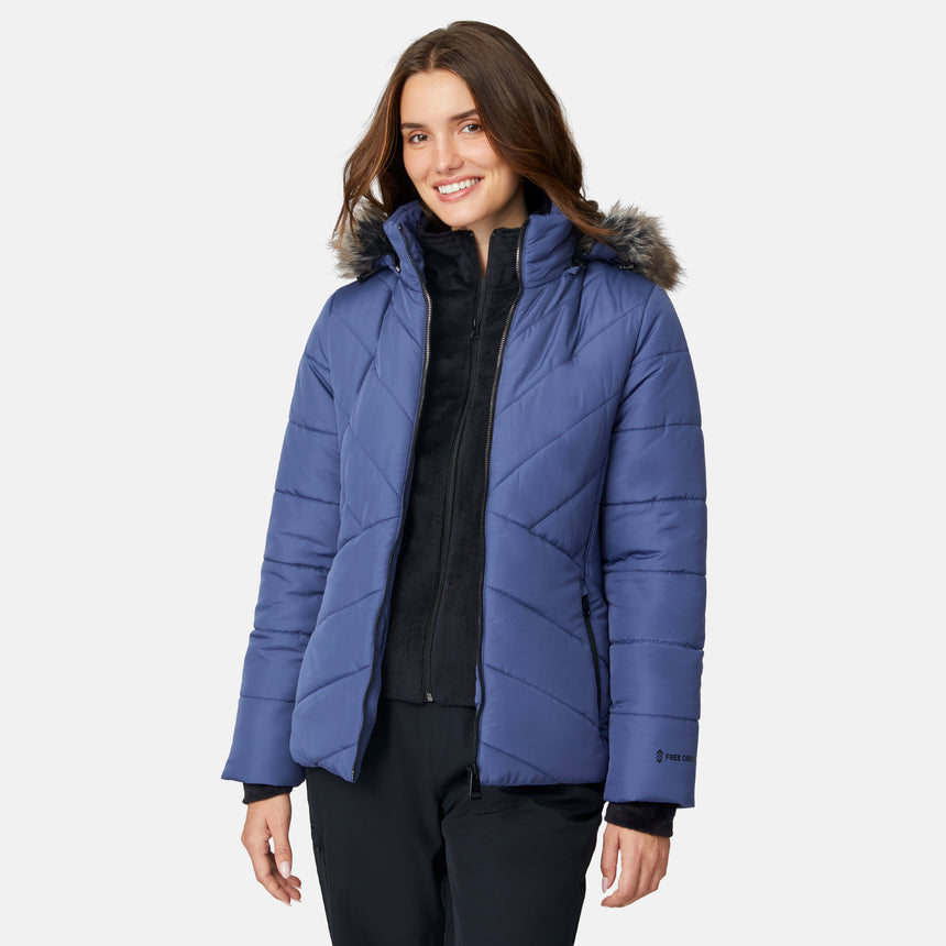 [Jessica is 5'9.5" wearing size S.] Woman wearing a blue puffer jacket with a fur-lined hood on a white background
