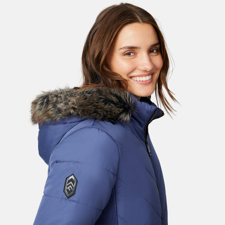 [Jessica is 5'9.5" wearing size S.] Woman wearing a blue puffer jacket with a fur-lined hood on a white background