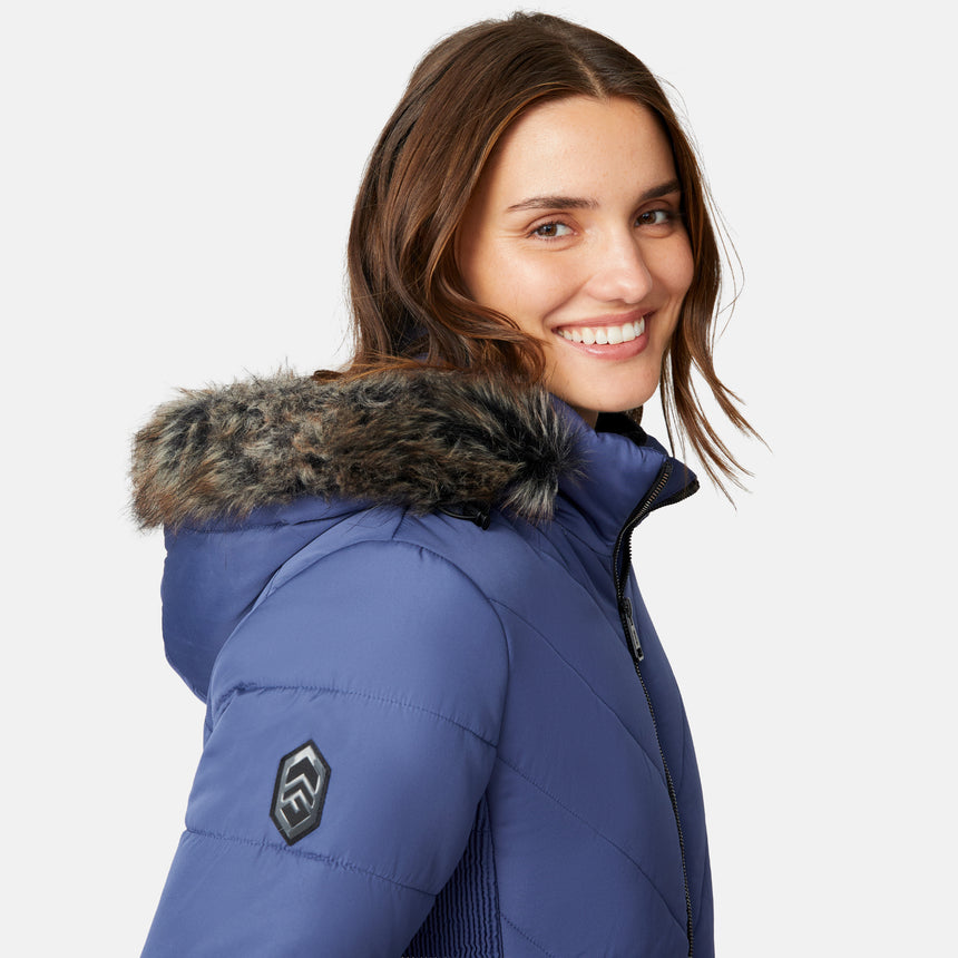 [Jessica is 5'9.5" wearing size S.] Woman wearing a blue puffer jacket with a fur-lined hood on a white background