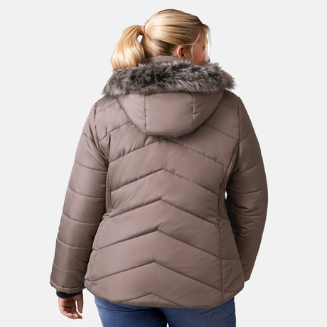 [Lola is 5'10.5" wearing a size 1X.] Woman wearing Free Country Women's Brisk II Parka Jacket in brown with a full front zipper opening, soft lining, attached hood with faux fur trim, recycled polyester fill, and water resistant and wind resistant stretch performance fabric, light grey background. Perfect women’s  jacket for fall weather.