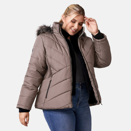 [Lola is 5'10.5" wearing a size 1X.] Woman wearing Free Country Women's Brisk II Parka Jacket in brown with a full front zipper opening, soft lining, attached hood with faux fur trim, recycled polyester fill, and water resistant and wind resistant stretch performance fabric, light grey background. Perfect women’s  jacket for fall weather.