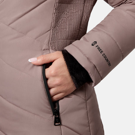 Close-up of a hand in the zippered pocket of a mauve quilted Women’s Brisk II Parka Jacket, featuring a black inner cuff.