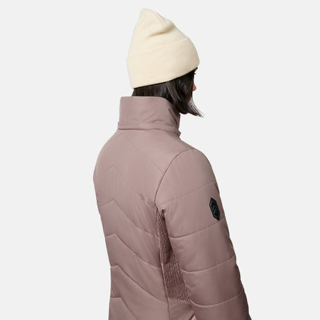 A person wearing a mauve Women’s Brisk II Parka Jacket with a high collar and a beanie hat.