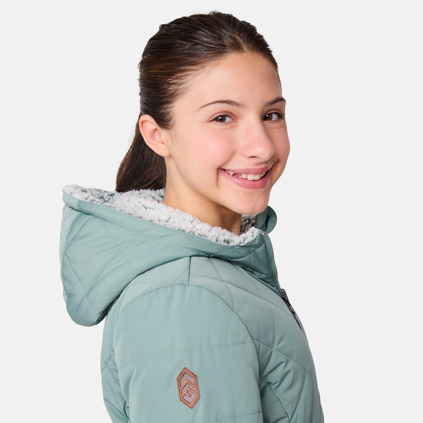 [Samantha is wearing size M] Model wearing a quilted light green Free Country hooded jacket with plush interior lining and full front zip; styled with denim for a relaxed, outdoors-ready look.