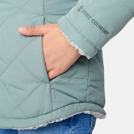 [Samantha is wearing size M] Model wearing a quilted light green Free Country hooded jacket with plush interior lining and full front zip; styled with denim for a relaxed, outdoors-ready look.