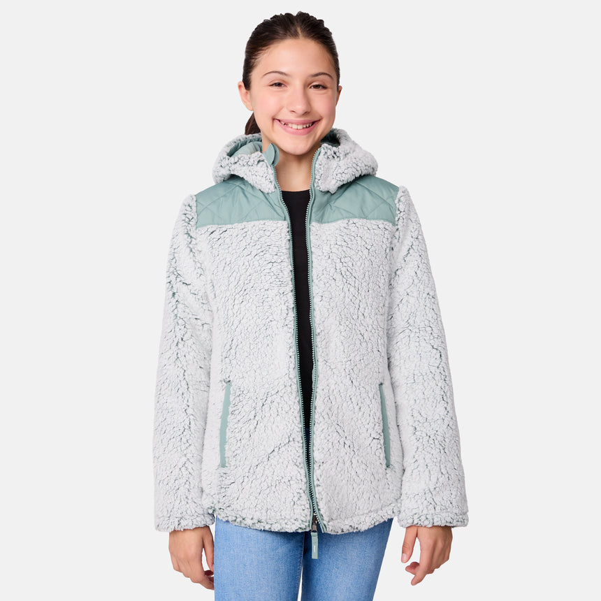 [Samantha is wearing size M] Model wearing a quilted light green Free Country hooded jacket with plush interior lining and full front zip; styled with denim for a relaxed, outdoors-ready look.
