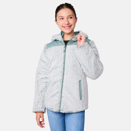 [Samantha is wearing size M] Model wearing a quilted light green Free Country hooded jacket with plush interior lining and full front zip; styled with denim for a relaxed, outdoors-ready look.