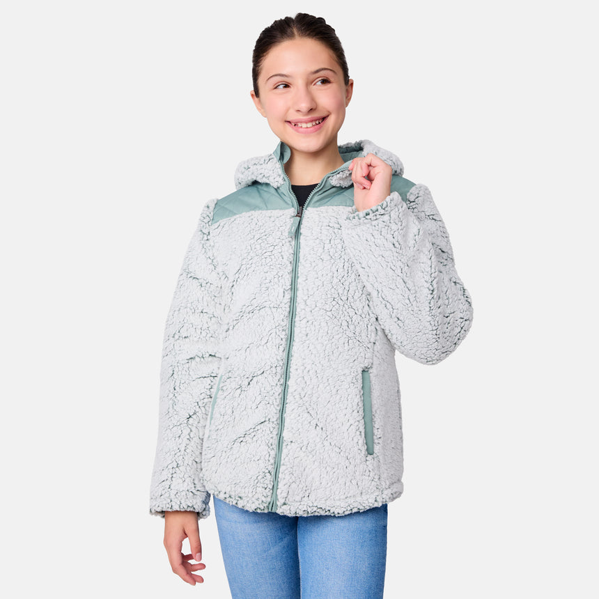 [Samantha is wearing size M] Model wearing a quilted light green Free Country hooded jacket with plush interior lining and full front zip; styled with denim for a relaxed, outdoors-ready look.