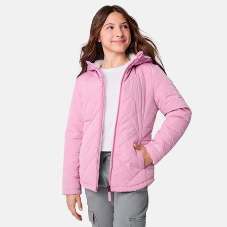 [Samantha is wearing size M] Model wearing a quilted light pink Free Country hooded jacket with diagonal stitching and soft interior lining; casually styled with gray utility pants and a white tee for a laid-back, trail-to-town vibe.