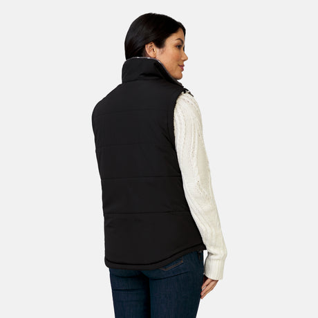 [Megan is 5’6” wearing a size Small.] Woman wearing the Free Country Women's Venture Stratus Lite Reversible Vest in black, featuring a geometric-print Butter Pile® lining and horizontal quilted overlay