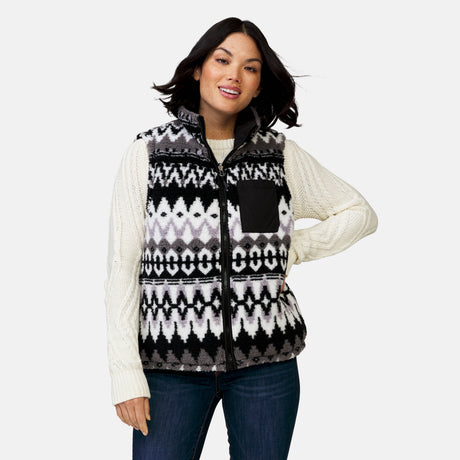 [Megan is 5’6” wearing a size Small.] Woman wearing the Free Country Women's Venture Stratus Lite Reversible Vest in black, featuring a geometric-print Butter Pile® lining and horizontal quilted overlay