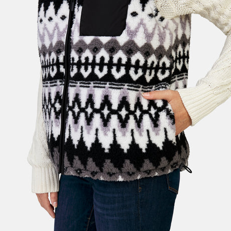 [Megan is 5’6” wearing a size Small.] Woman wearing the Free Country Women's Venture Stratus Lite Reversible Vest in black, featuring a geometric-print Butter Pile® lining and horizontal quilted overlay