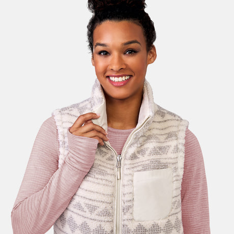 [Alexis is 5’6” wearing a size Small.] Woman wearing the Free Country Women's Venture Stratus Lite Reversible Vest in light gray, featuring a geometric-print Butter Pile® lining and horizontal quilted overlay