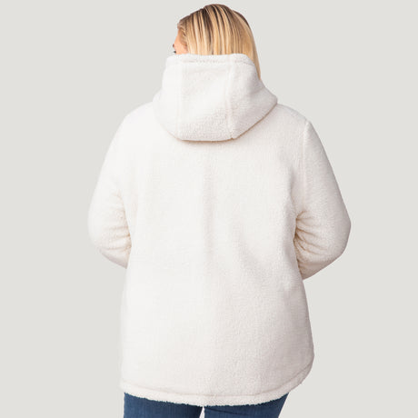 [Lola is 5'10.5" wearing a size 1X.] Woman wearing Free Country Women's Plus Size Switch It Up Cloud Lite Reversible Jacket in black with a full front zipper opening, attached hood with adjustable drawcord, diamond quilting, soft lining, and water resistant and wind resistant stretch performance fabric. light grey background. Perfect women’s  jacket for fall weather.
