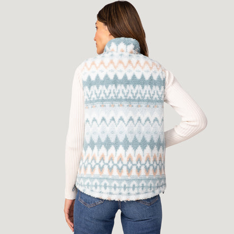 [Olga is 5’9" wearing a size Small.] Woman wearing the Free Country Women's Venture Stratus Lite Reversible Vest in light blue, featuring a geometric-print Butter Pile® lining and horizontal quilted overlay